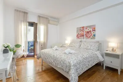 a white bedroom with a bed and a desk at Your Place in Rome Apartments in Rome