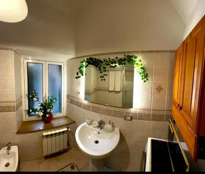 a bathroom with a sink and a mirror at Casa di Andrea in Trastevere in Rome