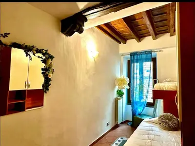 a bedroom with a bed and a window at Casa di Andrea in Trastevere in Rome