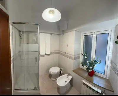 a bathroom with a shower and a toilet and a sink at Casa di Andrea in Trastevere in Rome