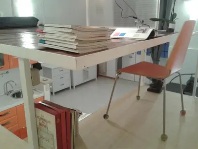 a desk with a stack of books and a chair at Termini Loft in Rome