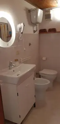 a bathroom with a sink and a toilet and a mirror at Termini Loft in Rome