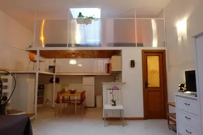a room with a loft bed and a dining room at Termini Loft in Rome