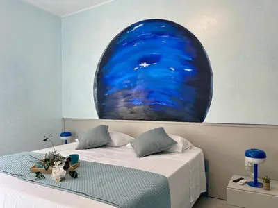 a bedroom with a bed with a large blue painting on the wall at Stellar Stays in Rome