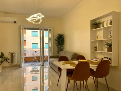a living room with a table and chairs at Stellar Stays in Rome