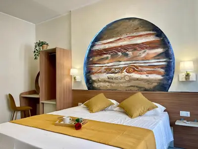 a bedroom with a bed and a painting on the wall at Stellar Stays in Rome