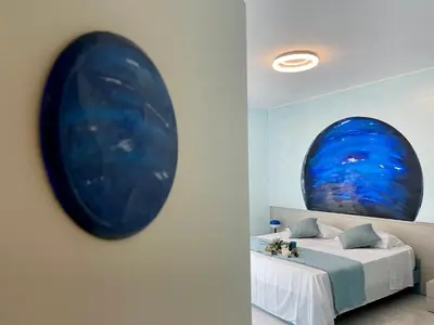 a bedroom with a large blue painting on the wall at Stellar Stays in Rome