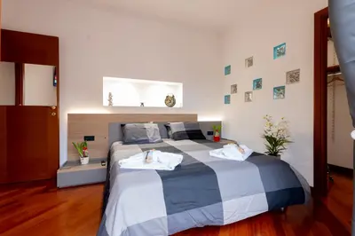 a bedroom with a large bed with towels on it at Graffiti Sweet Home in Rome