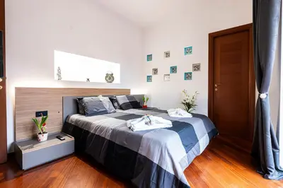 a bedroom with a bed with two towels on it at Graffiti Sweet Home in Rome