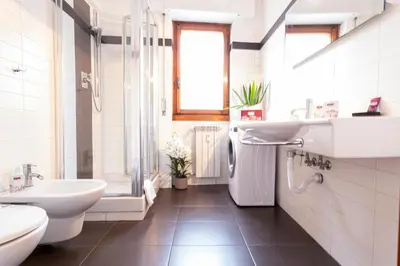 a bathroom with a sink and a toilet and a tub at Graffiti Sweet Home in Rome