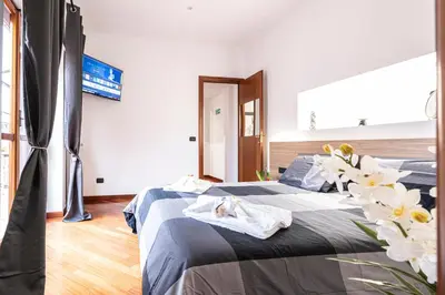 a bedroom with two beds with white flowers on it at Graffiti Sweet Home in Rome