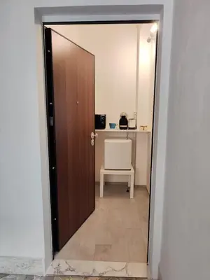 a door leading into a room with a desk and a chair at Rome Cozy Room in Rome
