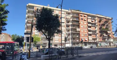 a large apartment building on a city street at Rome Cozy Room in Rome