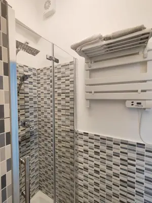 a shower in a bathroom with a glass shower backdoor at Rome Cozy Room in Rome