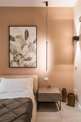 a bedroom with a bed and a table at GF Harmony Suite Colosseo in Rome