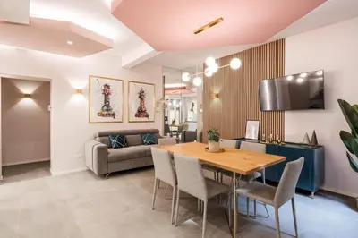 a living room with a table and a couch at GF Harmony Suite Colosseo in Rome