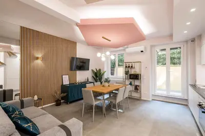 a living room with a table and a couch at GF Harmony Suite Colosseo in Rome