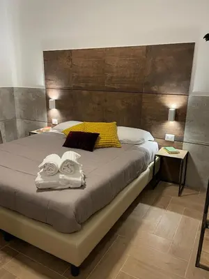 a bedroom with a bed with two towels on it at San Silverio B&B in Rome