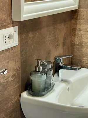 a bathroom sink with two cups on top of it at San Silverio B&B in Rome