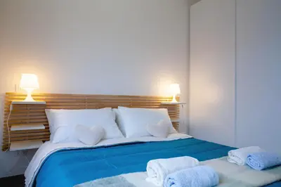 a bedroom with a large bed with towels on it at Saulo Boutique Apartment in Rome