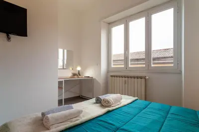 a bedroom with a bed with towels on it at Saulo Boutique Apartment in Rome