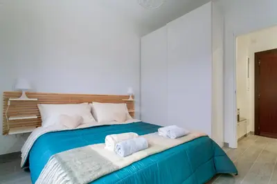 a bedroom with a large bed with towels on it at Saulo Boutique Apartment in Rome