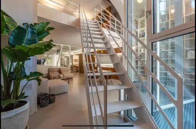 a spiral staircase in a house with a living room at Margutta Spagna Relais in Rome