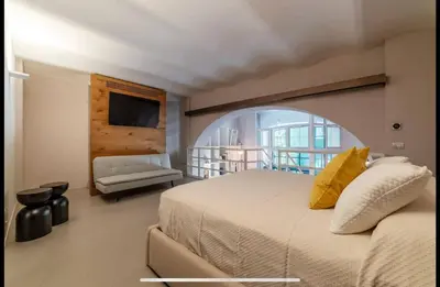 a bedroom with a large bed and a couch at Margutta Spagna Relais in Rome