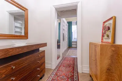 a bathroom with a mirror and a dresser and a rug at Spanish Steps Luxury Apartment in Rome
