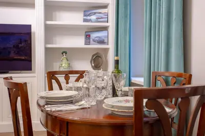 a dining room table with plates and wine glasses at Spanish Steps Luxury Apartment in Rome