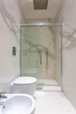 a bathroom with a shower and a toilet and a sink at Spanish Steps Luxury Apartment in Rome