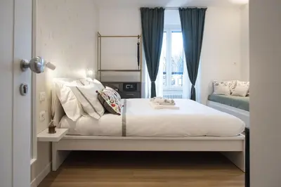a bedroom with a white bed with a window at Colosseum suites by Glen in Rome