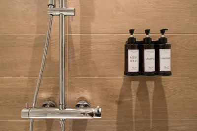 a group of three bottles on a wall at Colosseum suites by Glen in Rome