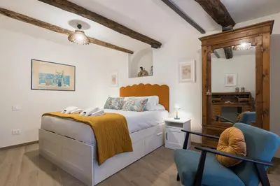 a bedroom with a bed and a chair at Rome As You Feel - Trastevere Nest with Secret Patio in Rome