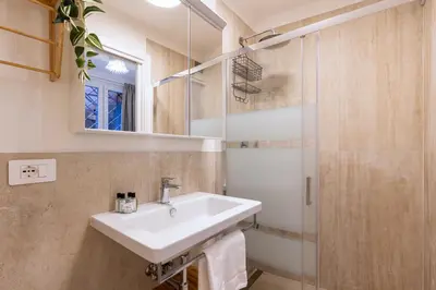 a bathroom with a sink and a shower at Rome As You Feel - Trastevere Nest with Secret Patio in Rome