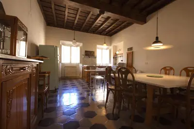 a kitchen and dining room with a table and chairs at Navona Large 1BR Holiday House in Rome