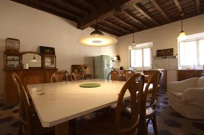 a kitchen and dining room with a table and chairs at Navona Large 1BR Holiday House in Rome