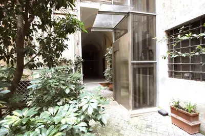 an entrance to a building with plants in a courtyard at Navona Large 1BR Holiday House in Rome