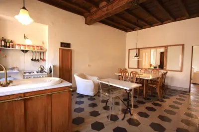a kitchen and dining room with a sink and a table at Navona Large 1BR Holiday House in Rome