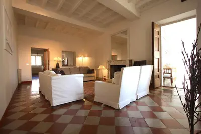 a living room with white chairs and a checkered floor at Navona Large 1BR Holiday House in Rome