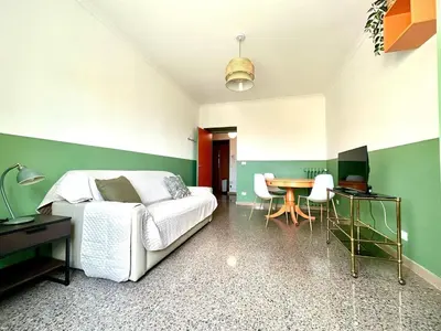 a bedroom with a bed and a table and chairs at Casa Dea Piramide in Rome