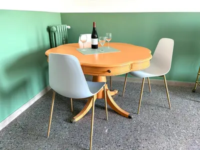 a wooden table with two chairs and a bottle of wine at Casa Dea Piramide in Rome