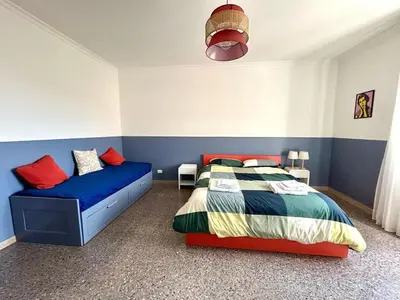 a bedroom with a bed and a couch at Casa Dea Piramide in Rome