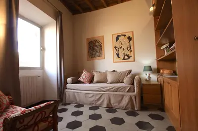 a bedroom with a bed and a window and a table at Navona Opera Holiday House in Rome