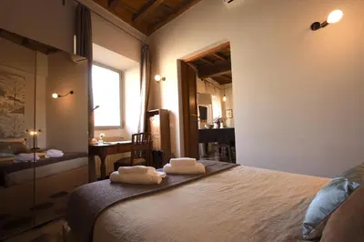 a bedroom with a bed with two towels on it at Navona Opera Holiday House in Rome