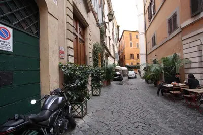 a motorcycle parked on the side of a street at Navona Opera Holiday House in Rome