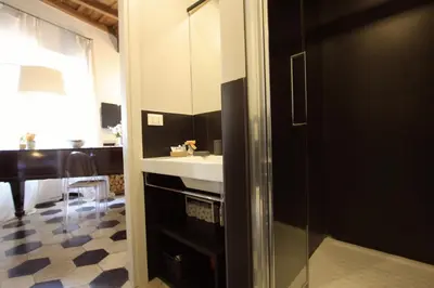 a bathroom with a sink and a mirror at Navona Opera Holiday House in Rome
