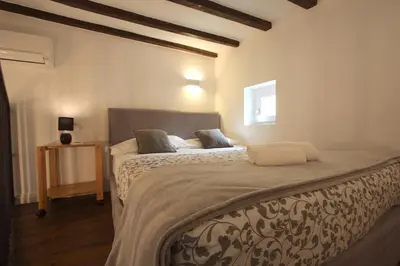 a bedroom with a large bed in a room at Navona Terrace 2BR Holiday House in Rome