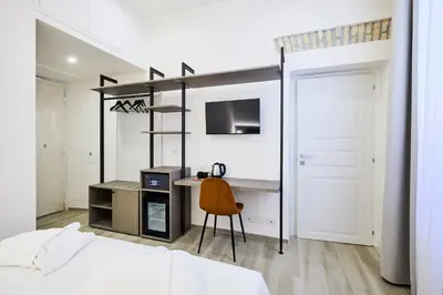 a bedroom with a loft bed with a desk and a chair at Urban Guesthouse Monti in Rome