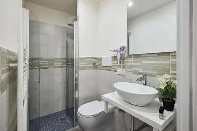 a bathroom with a sink and a toilet and a shower at Urban Guesthouse Monti in Rome